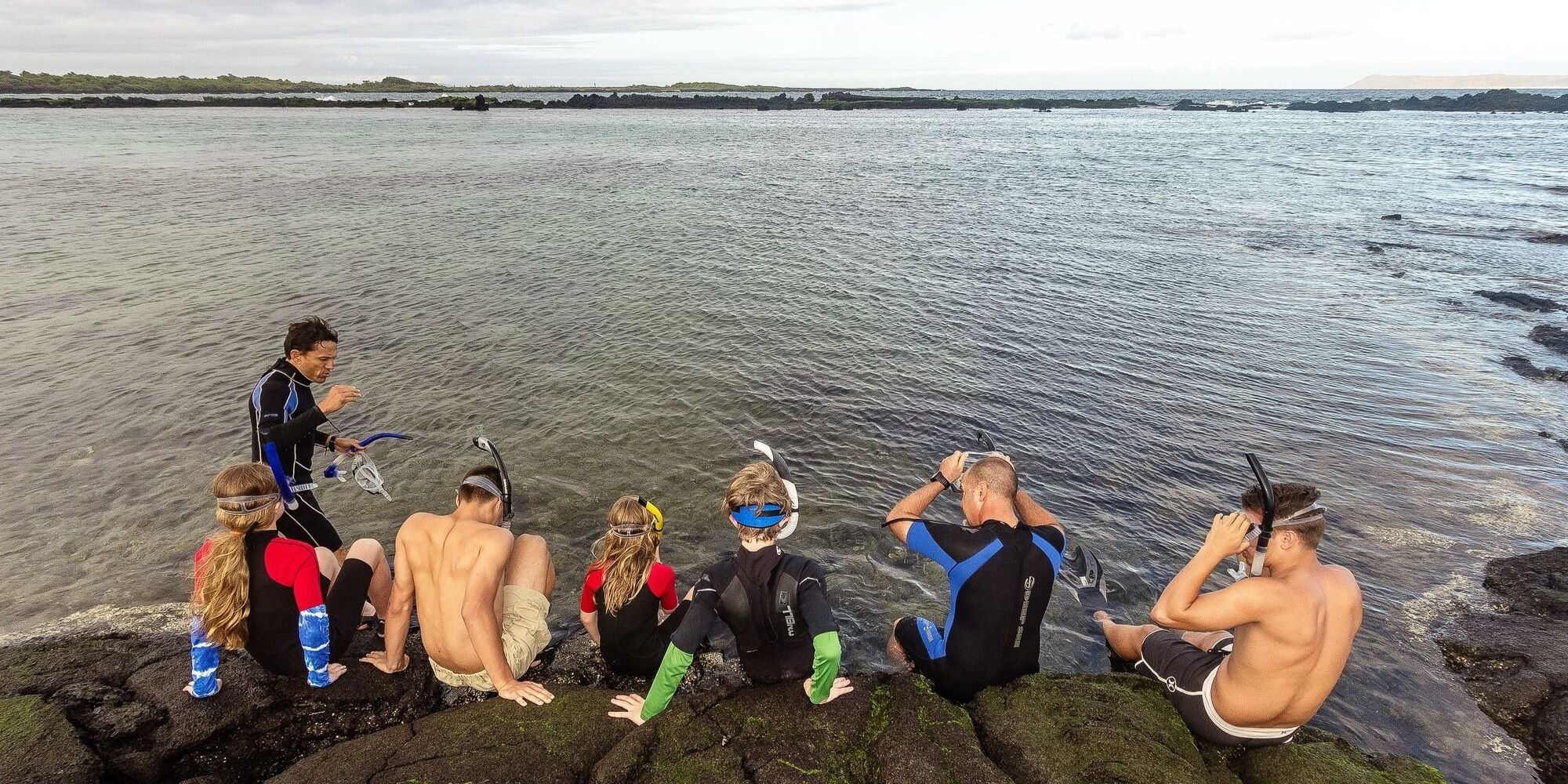 Family snorkeling in Galapagos Islands